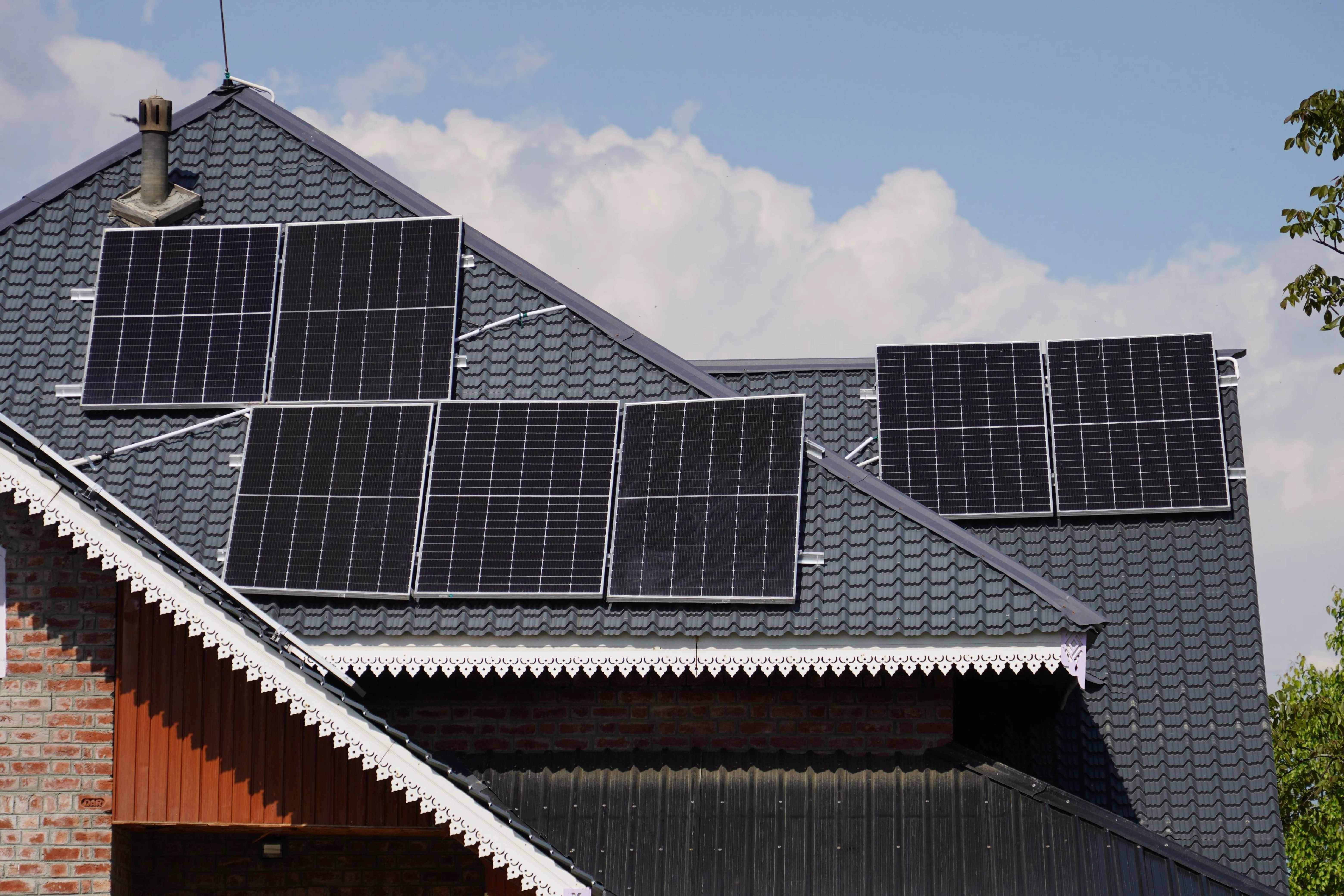 Rooftop solar panels installed on a residential house, illustrating if it is worth installing solar panels before winter on Long Island.